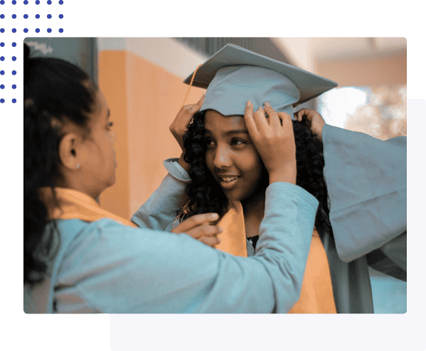 Image of graduate getting help with graduation cap